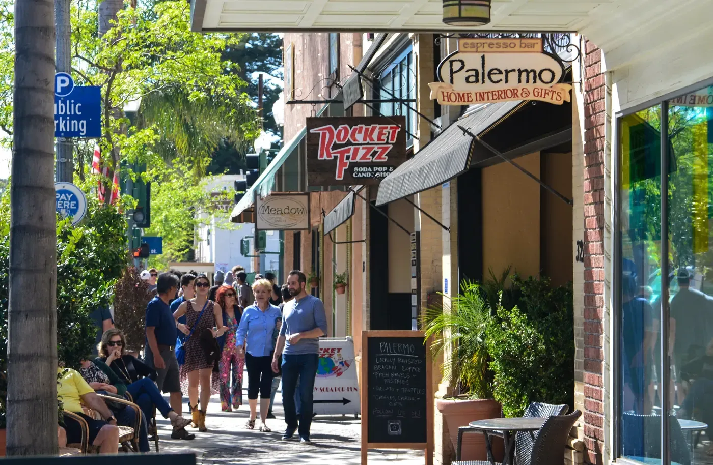 Shoppers along the Main Street sidewalk on a sunny afternoon
